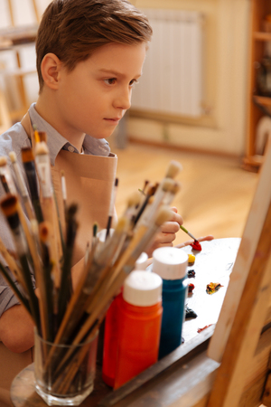 Capable kid having painting lesson at schoolの写真素材