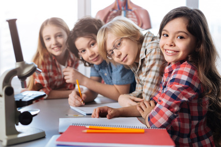 Team of little scientists enjoying biology class together