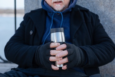 Close up of thermo cup being in male handsの写真素材