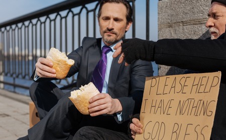 Photo of hungry men looking at small loaf