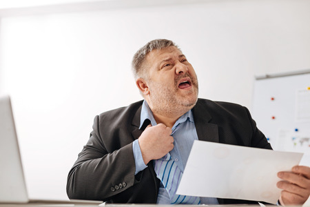 Unwell tired worker feeling stressed outの写真素材