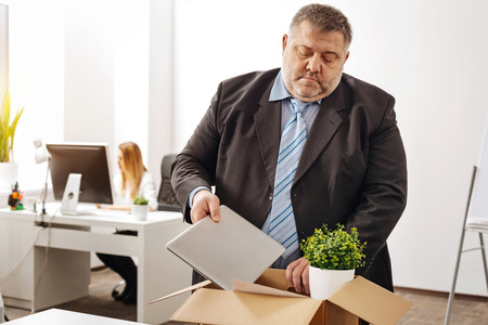Sad distressed office worker getting firedの写真素材