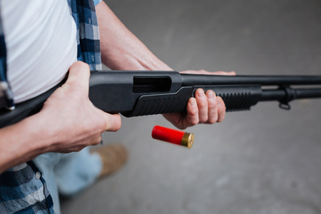 Red riffle bullet dropping out of the gunの写真素材