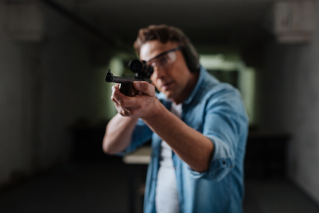 Serious brutal man hitting the targetの写真素材