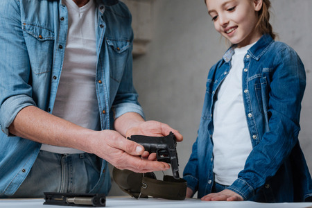 Good looking nice man holding a disassembled handgunの写真素材