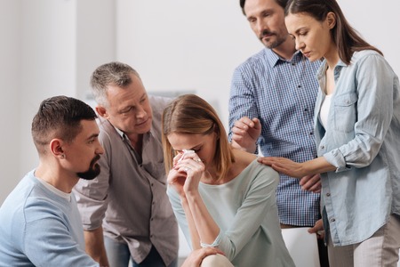 Worried female bowing her headの写真素材