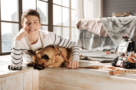 Portrait of smiling boy while embracing his dogの写真素材