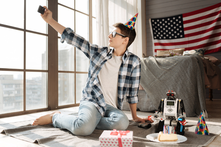 Patriotic teenager looking at panoramic windowの写真素材