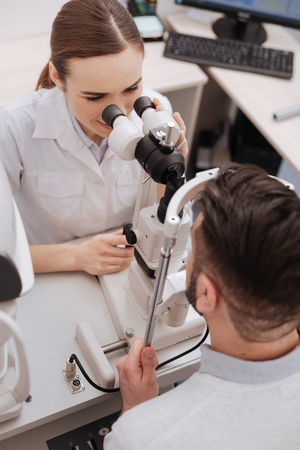 Top view of a female optician examining her patientの写真素材