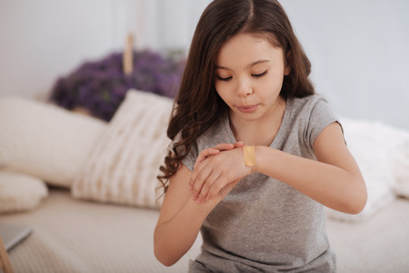 Careful little girl taking care of her health at homeの写真素材