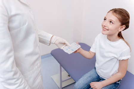 Attractive little patient sitting in consulting roomの写真素材