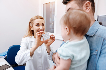 Back side of little patient while looking at nurseの写真素材