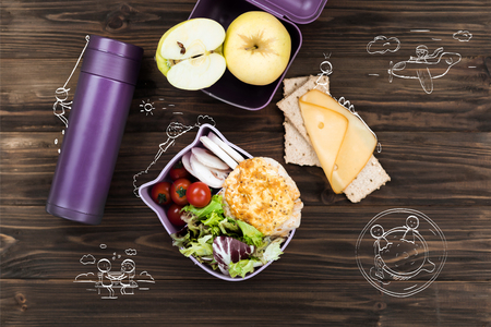 Top view of thermal bottle lying on the wooden tableの写真素材