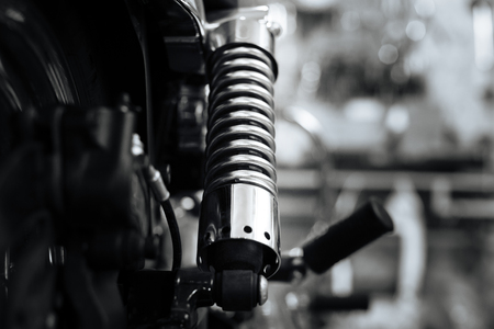New shock absorber being installed in classic motorbikeの写真素材
