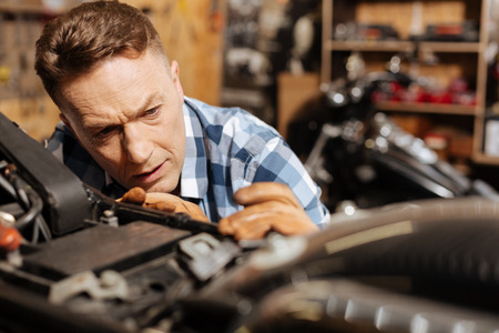 Skillful amateur mechanic making his bike perfectの写真素材