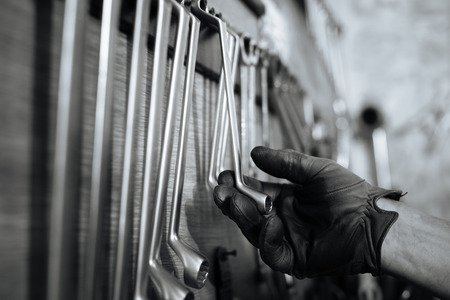 Accurate mechanic looking for the right size of a toolの写真素材