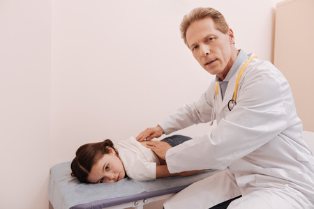 Concerned prominent expert indicating a problem with vertebraの写真素材