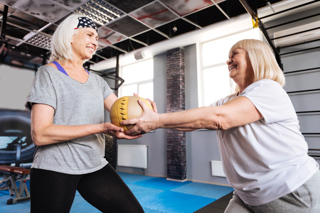 Cheerful aged women holding a ballの写真素材