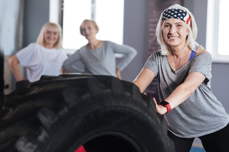 Happy retired woman developing her strengthの写真素材