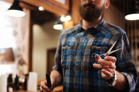 Close up of hairdressing scissors being in useの写真素材
