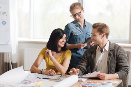 Happy hard working designers talking to each otherの写真素材