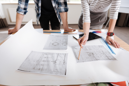 Close up of technical drawings lying on the tableの写真素材