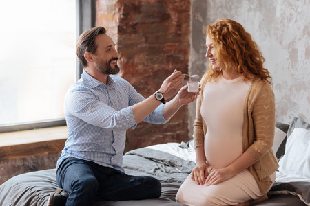 Sweet shot of husband taking care of pregnant wifeの写真素材