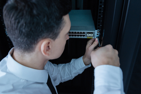 Nice professional technician using a screwdriverの写真素材
