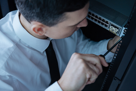 Professional male engineer turning a screwdriverの写真素材