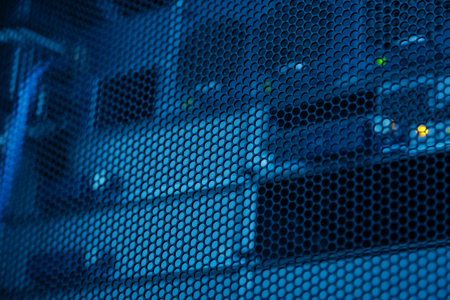 Computer equipment through the metal gridの写真素材