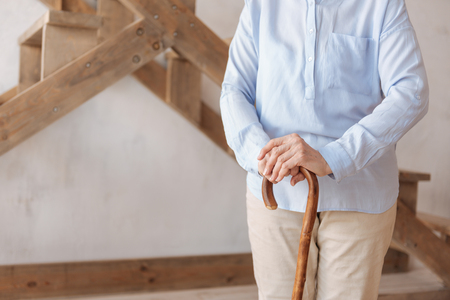 Close up of walking stick being in female handsの写真素材