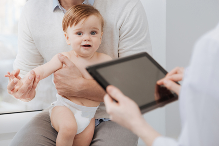 Sweet admirable child behaving nicely during the conversationの写真素材