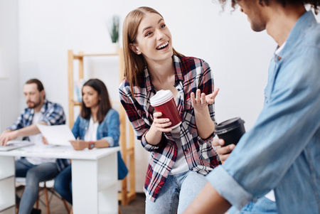 Emotional vibrant cool girl chatting excitedlyの写真素材