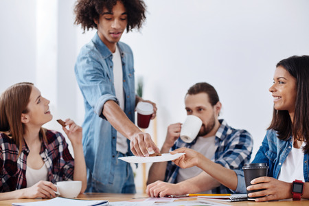 Adorable kind woman sharing cookies she bakingの写真素材