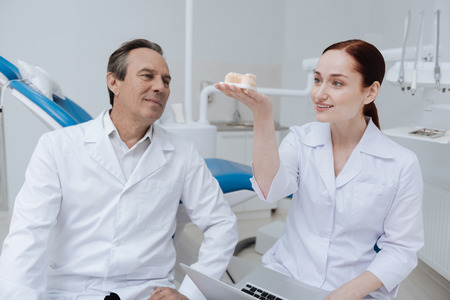 Attentive delighted dentist looking upwardsの写真素材