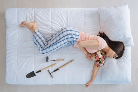 Peaceful attractive woman holding flowersの写真素材