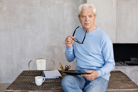 Mature classy man working in his home officeの写真素材