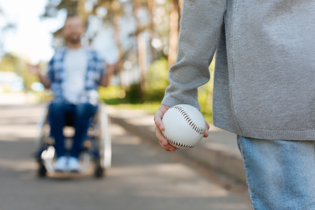 Close up of female hand than holding ball for baseballの写真素材