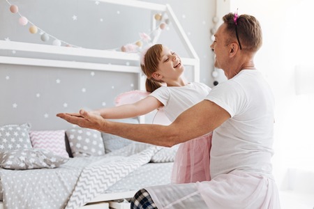 Talented dreamy girl loving dancing with dadの写真素材