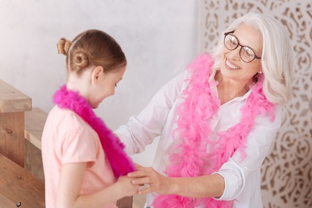Happy aged woman looking at her granddaughterの写真素材