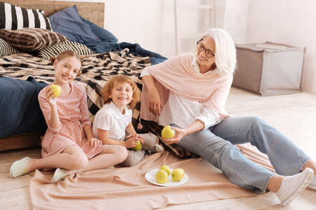 Positive nice children eating applesの写真素材