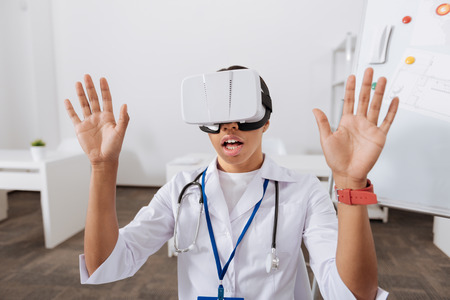 Pleasant beautiful woman pressing hands to the virtual screen