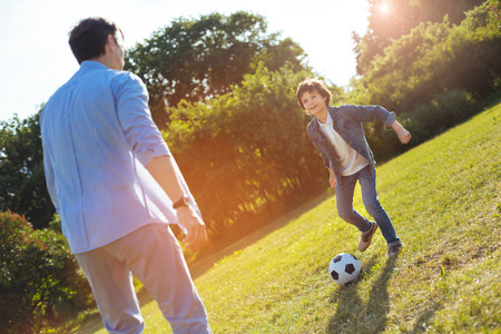 Charming emotional boy excited by the gameの写真素材