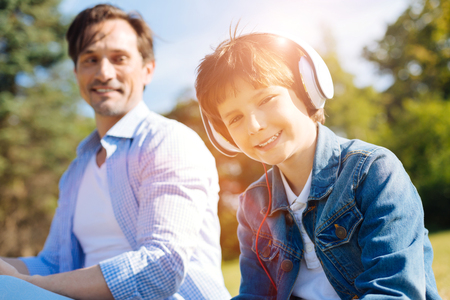Clever lively child enjoying the day with his fatherの写真素材