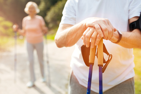 Close up of hands being put on the walking polesの写真素材