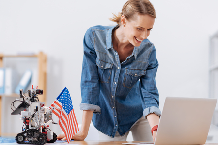 Lively designer enjoying electronic gadgets at workの写真素材