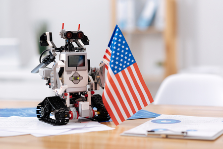 Patriotic robot standing on the table indoorsの写真素材
