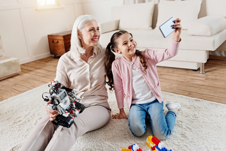 Happy senior female looking at telephone