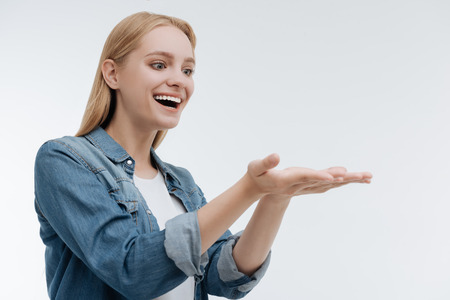 Amazing girl feeling happiness while presenting somethingの写真素材