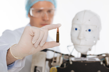 Serious brilliant scientist developing artificial intelligence for combatの写真素材